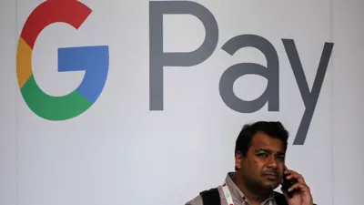 رجل يتحدث عبر الهاتف أمام شعار غوغل باي في مهرجان Global Fintech في مومباي، الهند، 5 سبتمبر 2023.